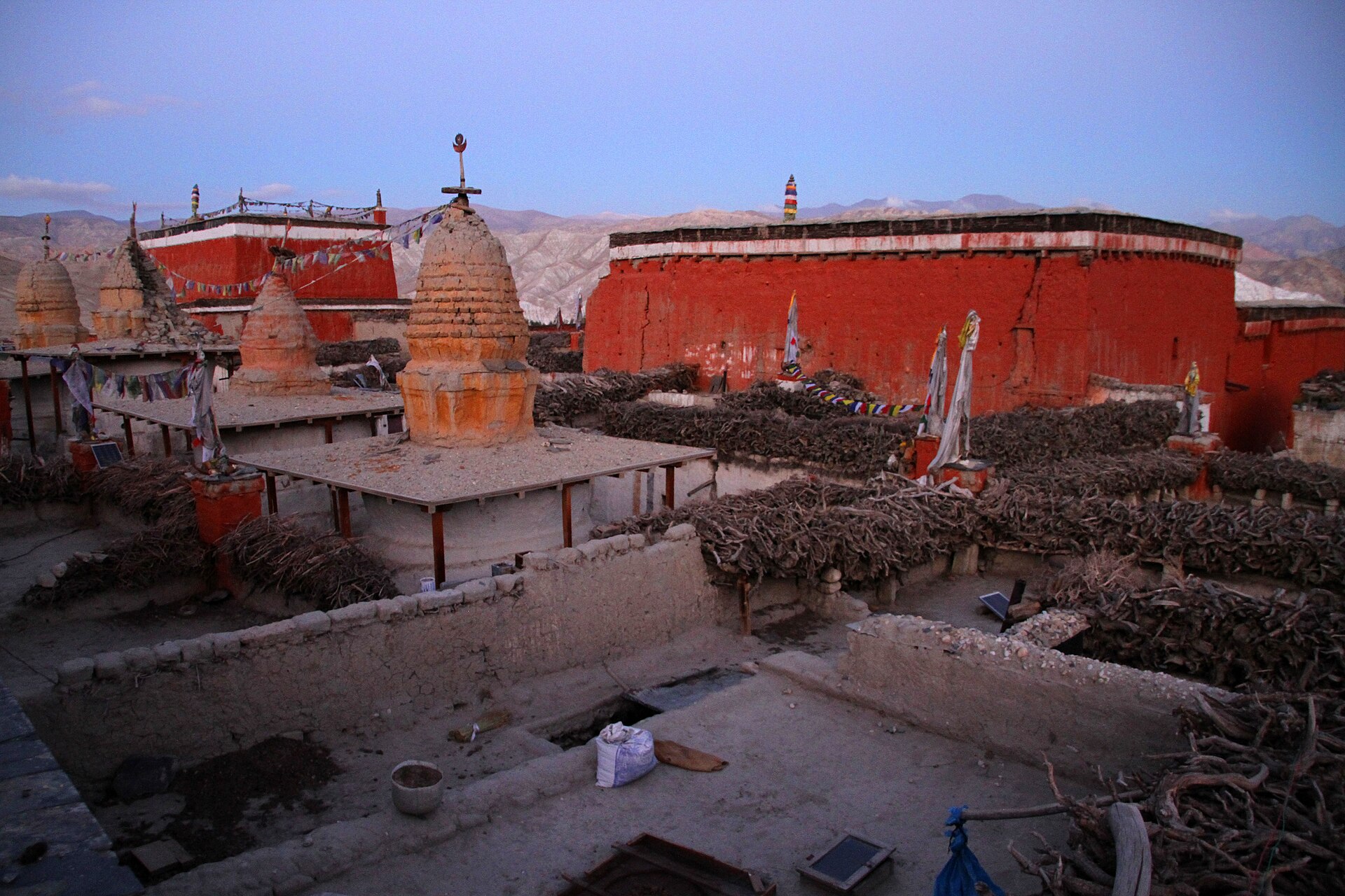 The red monastery walls and earthen chortens of Lo Manthang at dusk